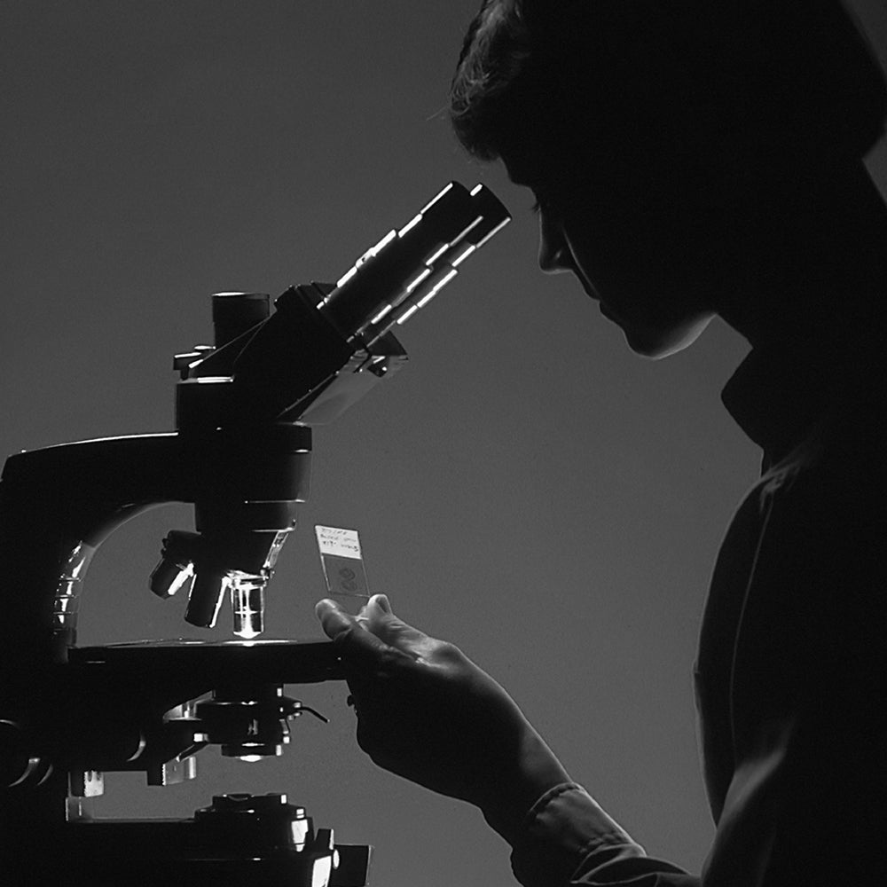 Woman using microscope